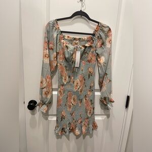 Brand new smocked Timing dress in blue floral. Never worn, with tags.